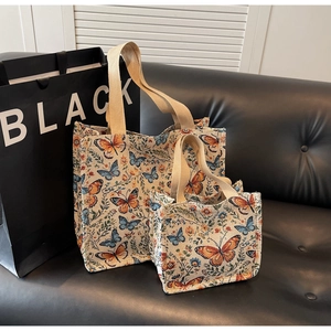 Macro detail of canvas tote bags with butterfly floral print and thick cotton handles