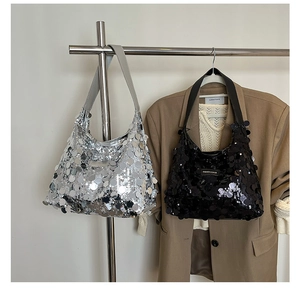Close-up of stylish sequin tote bags in black and silver featuring large mirror discs