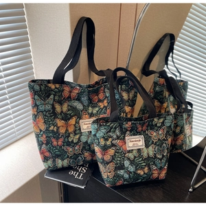 Detail of large and small vintage green butterfly print tote bags with jacquard fabric