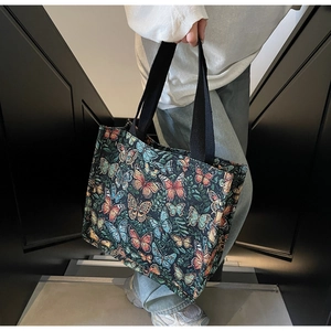 Close-up of colorful butterfly jacquard pattern on a large vintage tote bag