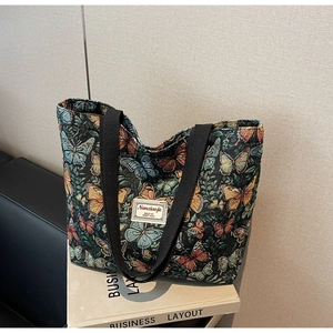 Close-up of floral butterfly jacquard fabric on a large capacity tote bag with texture