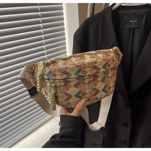 Close-up of ethnic geometric jacquard fabric and woven rope zip puller on chest bag