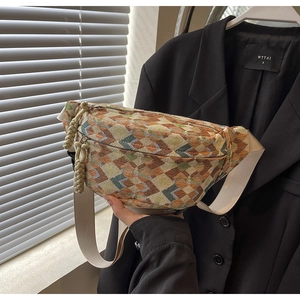 Detailed macro of vintage woven crossbody bag with geometric diamond patterns and dual zippers