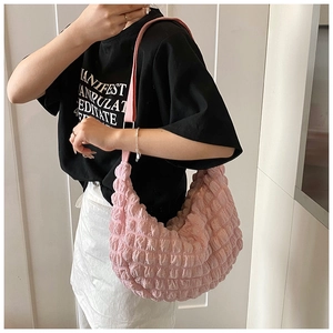 Detail of pink gathered hobo bag with textured bubble fabric and matching shoulder strap