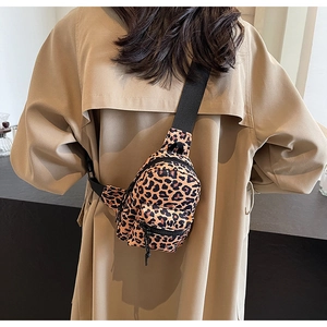 Leopard print crossbody bag with multiple zip pockets and adjustable wide black strap