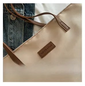 Detail of beige tote bag fabric and leather handle with Fashion & Bags leather label
