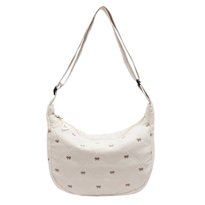 Quilted bow crossbody dumpling bag with adjustable shoulder strap in creamy white