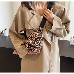 Detail view of leopard print crossbody chest bag with adjustable black nylon strap