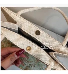 Detail of strong magnetic snap closure on beige embroidered linen tote bag
