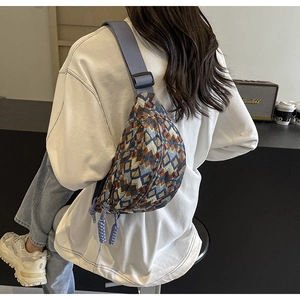 Detailed back view of vintage geometric woven crossbody bag with colorful patterns