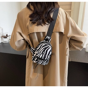 Zebra print mini chest bag shown from behind on a model wearing a brown coat