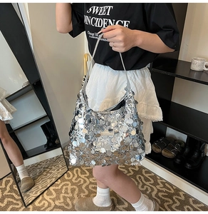 Detail showing shiny silver sequins and metallic texture on a trendy shoulder tote bag