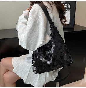 Close-up of black sequined tote bag with Fashion & Bags label and leather strap