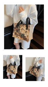 Close-up of vintage floral jacquard tote bag with rustic linen side panels and black handles