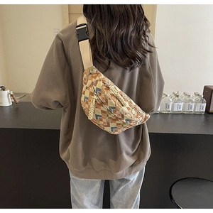 Close-up of vintage geometric pattern on a crossbody chest bag with adjustable strap