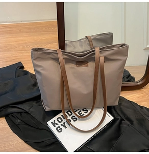Detail showing high-quality khaki nylon fabric and brown leather handle on tote bag