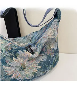 Close-up of floral oil painting tote bag featuring dual metal zippers and durable blue strap