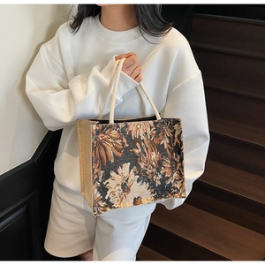 Detail of floral tapestry tote with linen sides and soft white cotton rope handles