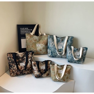 Three vintage floral jacquard canvas tote bags in various sizes and patterns on display