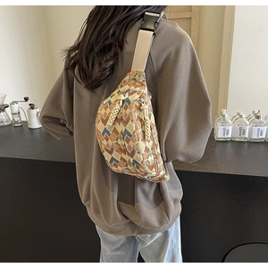 Close-up of bohemian style crossbody bag with geometric pattern and woven zipper pull