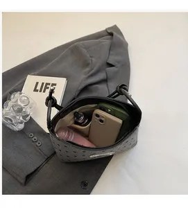 Spacious interior of canvas polka dot bag showing compartments for phones and cosmetics