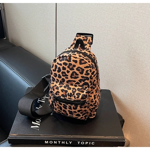 Macro view of leopard print mini crossbody bag showing premium nylon fabric and zipper pocket