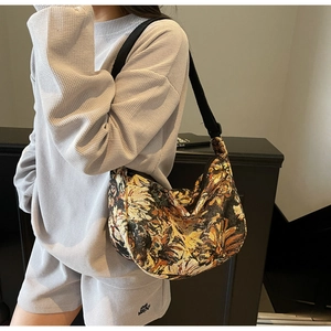 Detail view of the vintage floral tapestry fabric and adjustable wide shoulder strap