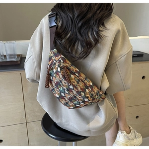 Close-up of bohemian crossbody bag with colorful geometric patterns and adjustable strap