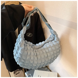 Close-up of light blue bubble textured puffy shoulder bag with ruched fabric detail