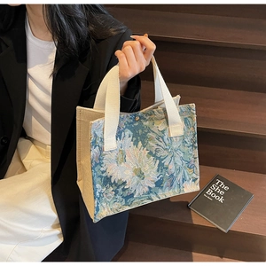 Detail of floral tapestry tote bag in cotton linen with canvas handle and rustic texture
