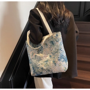 Detail of artistic canvas tote bag with jacquard oil painting texture and wide strap