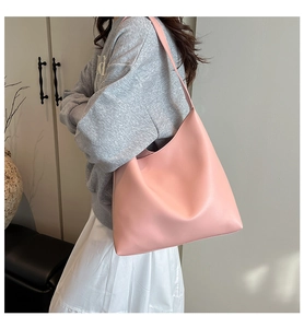 Close-up of pink soft leather tote bag showing spacious capacity and wide shoulder strap