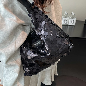 Fashionable black sequin tote bag with a rectangular logo patch and shoulder strap