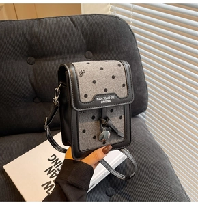 Détail du sac bandoulière vintage en tissu à pois gris et cuir noir petit format