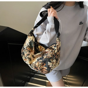 Detailed close-up of vintage oil painting style floral jacquard fabric on crescent bag