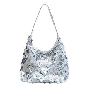 Chic silver sequin tote bag with large round sequins and fashion label on white background