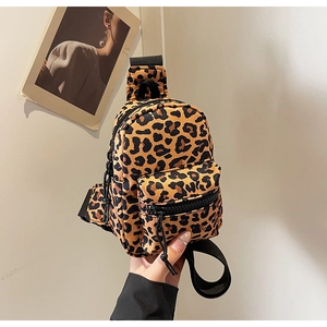 Close-up of leopard print mini chest bag with front zipper and nylon strap detail