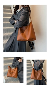 Detail view of large caramel brown leather shoulder bag showing matte texture and wide strap