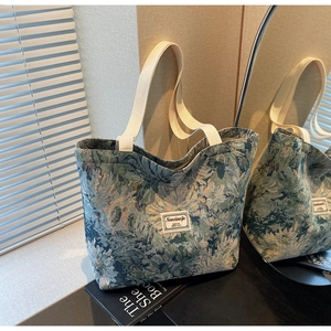 Detailed close-up of blue floral jacquard tote bag with stylish cotton webbing handles