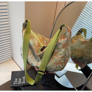 Detail of vintage floral jacquard fabric texture and adjustable wide green shoulder strap