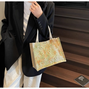 Detail of floral embroidery canvas tote bag with cotton rope handles and magnetic snap closure