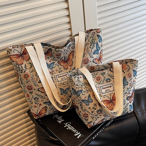 Floral embroidered tote bag set featuring butterfly patterns and wide woven straps
