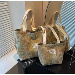 Macro detail of retro floral jacquard tote bags with white handles on a dark table