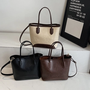 Chic retro faux leather bucket bags in white, black, and brown for elegant office commuting