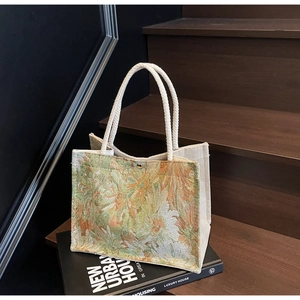 Detailed close-up of floral jacquard embroidery tote bag with white rope handles