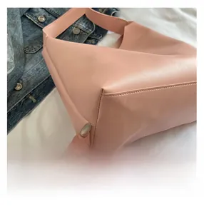 Detail shot of pink hobo bag showing high-quality stitching and smooth PU leather texture