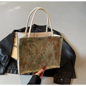 Detail of vintage oil painting style jacquard fabric and woven rope handle on tote bag