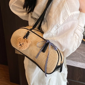 Minimalist straw woven cylinder shoulder bag with black leather trim and cute bear charm