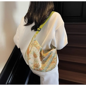 Detailed texture of crescent crossbody bag with vintage floral oil painting pattern
