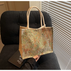 Detail of vintage floral jacquard tote with cream cotton rope handles and magnetic closure